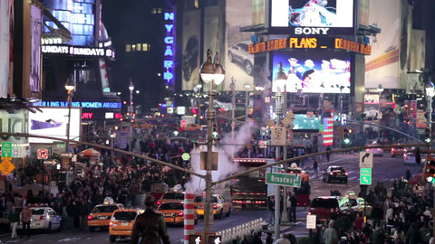 high view of Times Square at night with construction pipe blowing smoke