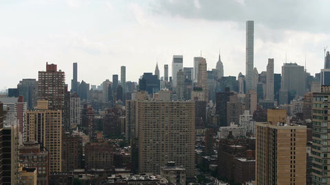 aerial over Manhattan buildings toward Empire State Building