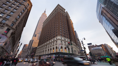 busy street view of Empire State Building from Herald Square with people and traffic during day - 4K time-lapse Manhattan