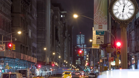 famous 5th Ave clock at night in Manhattan - traffic lights changing, timelapse pulling back in 4K and 1080 HD in NYC