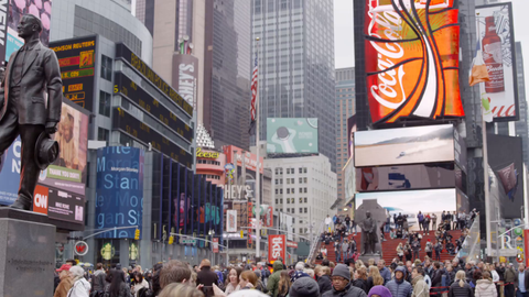 moving through crowded Times Square busy with people - tourists visiting New York City on cold winter day in 4K slow motion