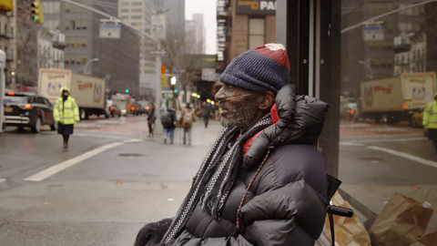 homeless man with oxygen tank and wheelchair on cold winter day begging for change on Manhattan street in 4K NYC