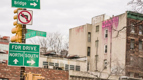 FDR Drive sign - north and south arrows on Bowery and Mulberry Street in Chinatown on bright cloudy day