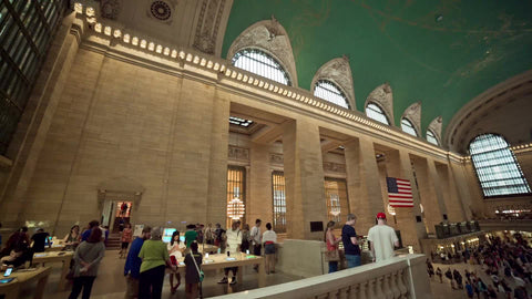 Grand Central Station Terminal panning across crowded interior with people busy traveling in summer in NYC