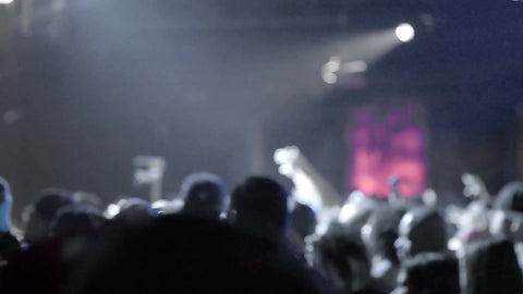 slow motion crowd of hip hop fans zooming out, watching rap show from audience