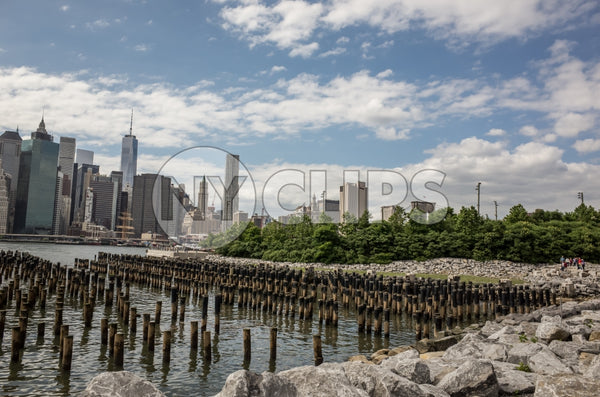 wooden dowels on East River water with Manhattan skyline in New York City