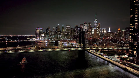 aerial over Manhattan Bridge East River New York City at night