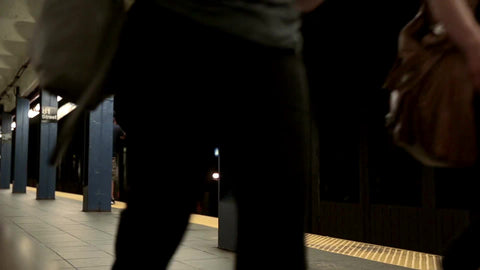 low view of subway station platform as express train is passing on other track