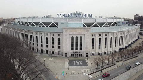 Yankee Stadium aerial fly over - drone flying above front entrance sign in The Bronx New York City NYC in 4K and 1080 HD