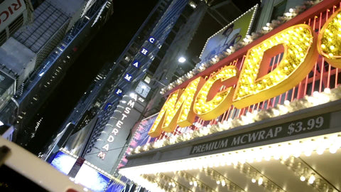 panning across bright McDonald's sign at night off Times Square