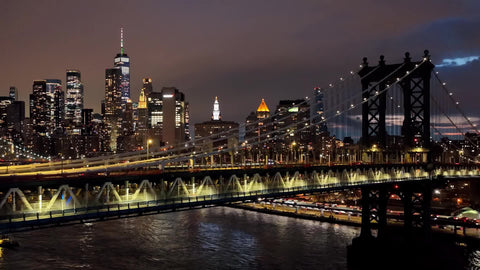 Freedom Tower and Manhattan Bridge at night skyline lights East River water New York City NYC