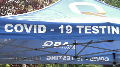 man getting Covid test q-tip up nose testing on street New York City