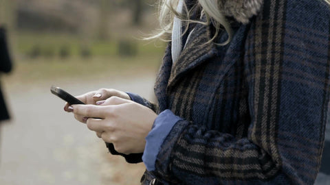 woman on phone texting in autumn in New York City