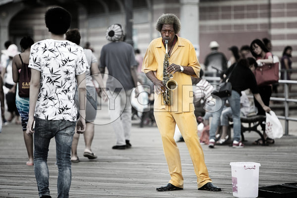 musician playing saxophone on street in New York City