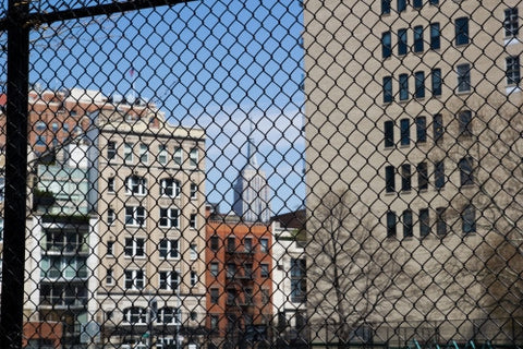 Empire State Building view through fence