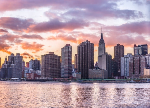 Manhattan skyline with Empire State Building from across East River in colorful HDR sunset