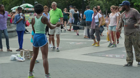little kid playing double dutch in Washington Square Park on summer day in NYC