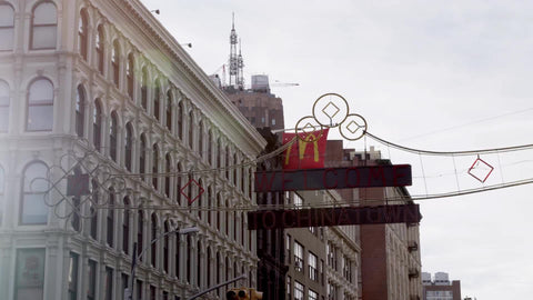 welcome to Chinatown sign overhead - bright sunny day in slow motion