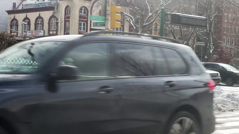 man on corner on cold winter day with snow - gritty Lower East Side street in Downtown Manhattan New York City NYC