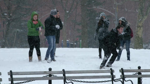 girl throwing snowball in winter blizzard Washington Square Park snowing slow motion 4K