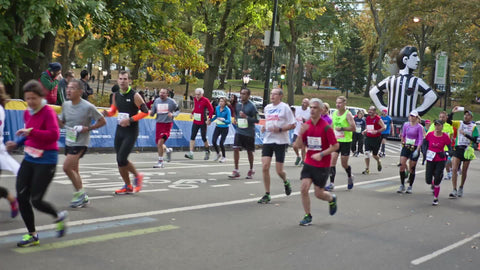 people running last mile in marathon, Central Park with Foot Locker balloon in Manhattan NYC