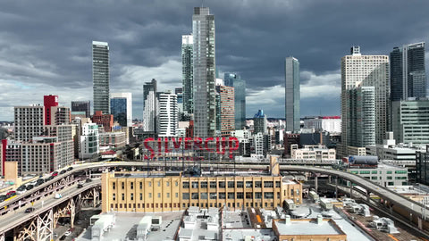 aerial toward Silvercup sign and subway elevated train Queens New York City slow