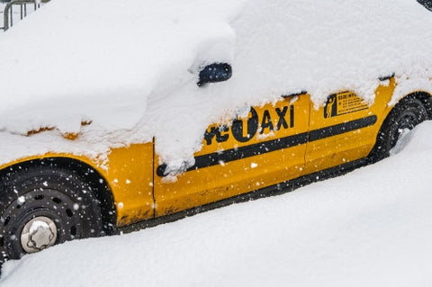 taxi cab covered in snow - snowing in winter storm