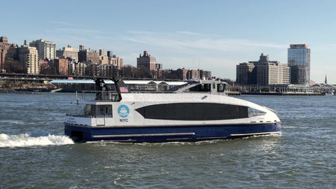 Lunchbox ferry tour boat in East River passing Brooklyn New York City NYC