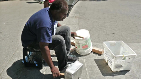 drummer using pots pans and bucket for percussion - spoken word while drumming metal in Washington Square Park in NYC