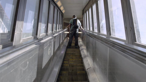 up escalator in 125th street subway station in Harlem - kid with backpack riding escalator going up