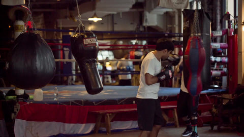 boxing gym in Lower Manhattan with people training on heavybags