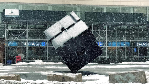 Astor Place cube sculpture in Cooper Square in snow storm - snowing in winter blizzard in New York City NYC