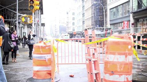 construction worker holding traffic sign on street bright sunny day Broadway Downtown Manhattan NYC