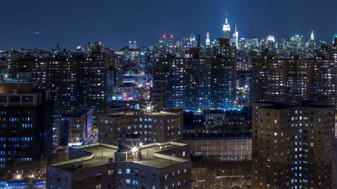 panning Manhattan skyline at night from LES red brick housing project buildings - 4K timelapse