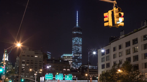 Freedom Tower at night with signs for Brooklyn and Hudson Street - 4K timelapse in Downtown Manhattan New York City