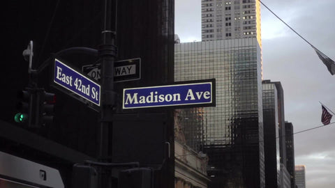 East 42nd Street and Madison Ave sign on street corner intersection, zooming out to busy crowded street with Chrysler Building in wide shot, Manhattan NYC 1080p HD