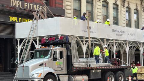 construction workers in hardhats building scaffolding in New York City NYC