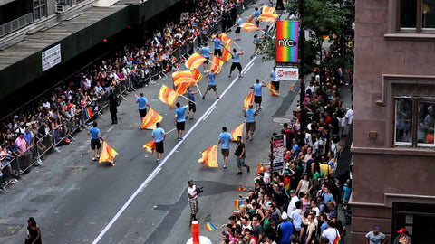 gay pride parade on lower 5th ave - overhead view of crowded street - people marching with LGBT rainbow flags