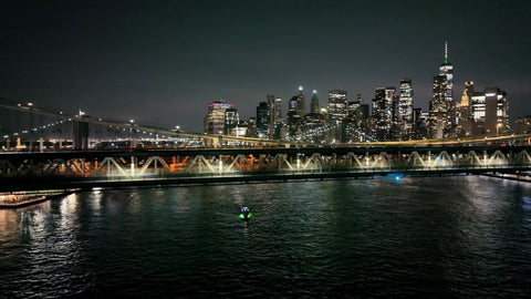 aerial following cars Manhattan Bridge night New York City