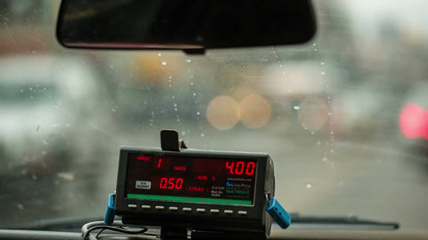 taxi cab coming to stop behind Honda - 4 dollars on meter