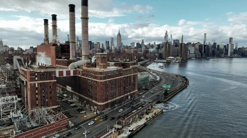 daytime industrial Brooklyn factory smoke stacks East River Manhattan skyline Empire State Building New York City NYC