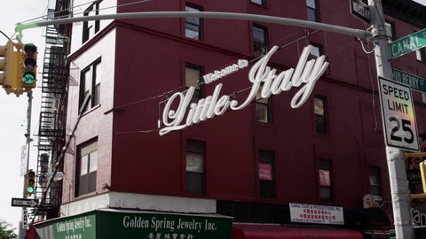Welcome to Little Italy sign overhead - driving on Canal Street in slow motion downtown on fall day