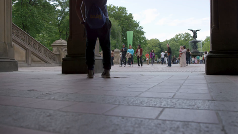 tourist taking picture of angel statue from underneath Bethesda Terrace in Central Park on summer day - 4K NYC