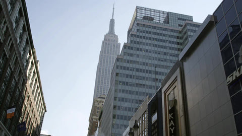 driving toward Empire State Building with smoke and steam in Midtown Manhattan