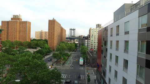 aerial over Lower East Side with Manhattan Bridge in background on summer day in NYC