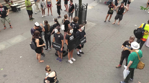overhead aerial flyover Anonymous Truth protesters demonstrating at Union Square in New York City NYC
