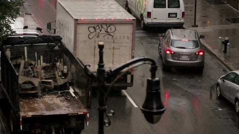 firetruck honking in traffic with siren and flashing lights - FDNY fire truck - raining in NYC