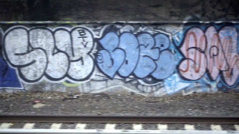 beautiful graffiti pieces in subway tunnel over tracks - gritty urban art viewed from B train in 1080 HD NYC