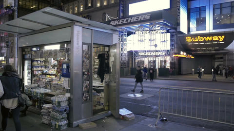 newsstand and exterior subway entrance on 42nd street at night