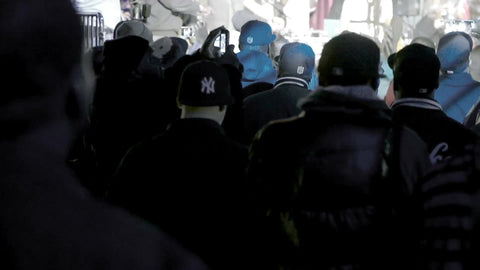 fans in audience with Yankee jacket watching Smif n Wessun rap show live in concert - crowd facing stage